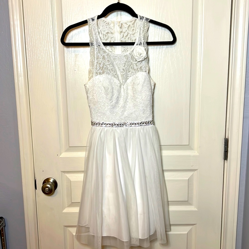 Lovely junior white lace dress with back cut out. Silver sequins detail. Size 1